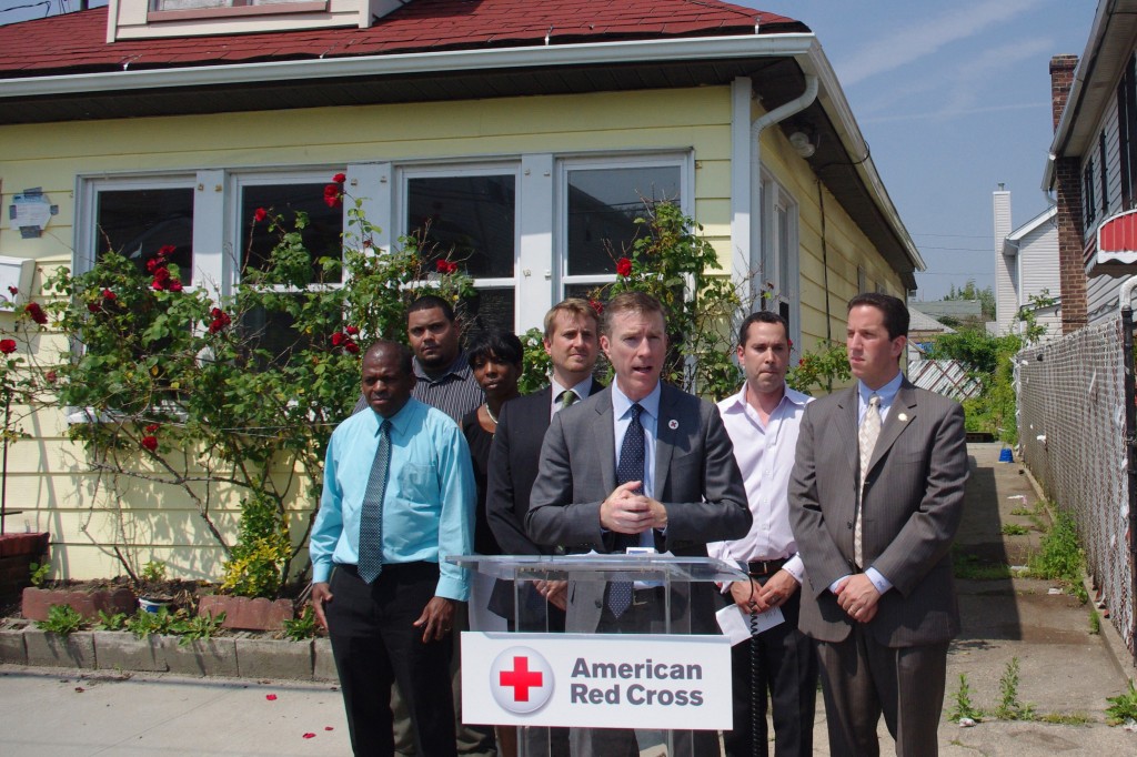 Rockaway homeowner Felix Lyons, left; Friends of Rockaway Apprentice Joseph Lopez; Lynette Shelborne-Barfield, constituent liaison for state Sen. James Sanders, Jr; Friends of Rockaway Director Todd Miner; American Red Cross Greater New York Region CEO Josh Lockwood; Friends of Rockaway Founder Michael Sinensky; and state Assemblyman Phil Goldfeder gather to announce the American Red Cross awarded a $721,550 grant to Friends of Rockaway this week. Photo Courtesy of the American Red Cross 