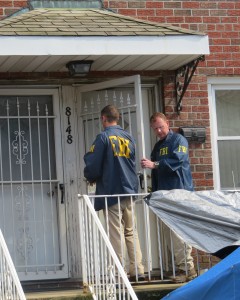 FBI agents knock on the door of notorious mobster Jimmy Burke’s former house in Ozone Park, where his daughter now lives. Anna Gustafson/The Forum Newsgroup