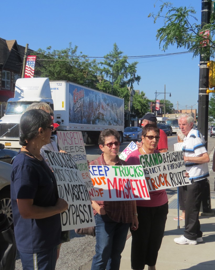 Residents, civic leaders and legislators gathered in Maspeth last Thursday to protest trucks continuing to use Flushing and Grand avenues to avoid traffic on the Long Island Expressway. Anna Gustafson/The Forum Newsgroup