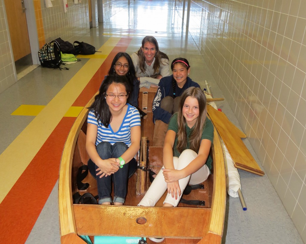 Metropolitan Expeditionary Learning School sailboat club members Sydney Lundin, clockwise from front right, Jody Huie, Gaby Astacio and Tedy Hofman, and their club’s advisor, science teacher Abbie Sewall, pose with the boat they built throughout the course of the past school year. Anna Gustafson/The Forum Newsgroup