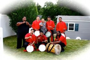 The Aman Tassa Group of drummers was performing at the event. One of the drummers has been identified as the man who struck Zaman Amin with the trophy and split his head. The man allegedly identified is seen in this photo at the far left side in the back row. Facebook Photo