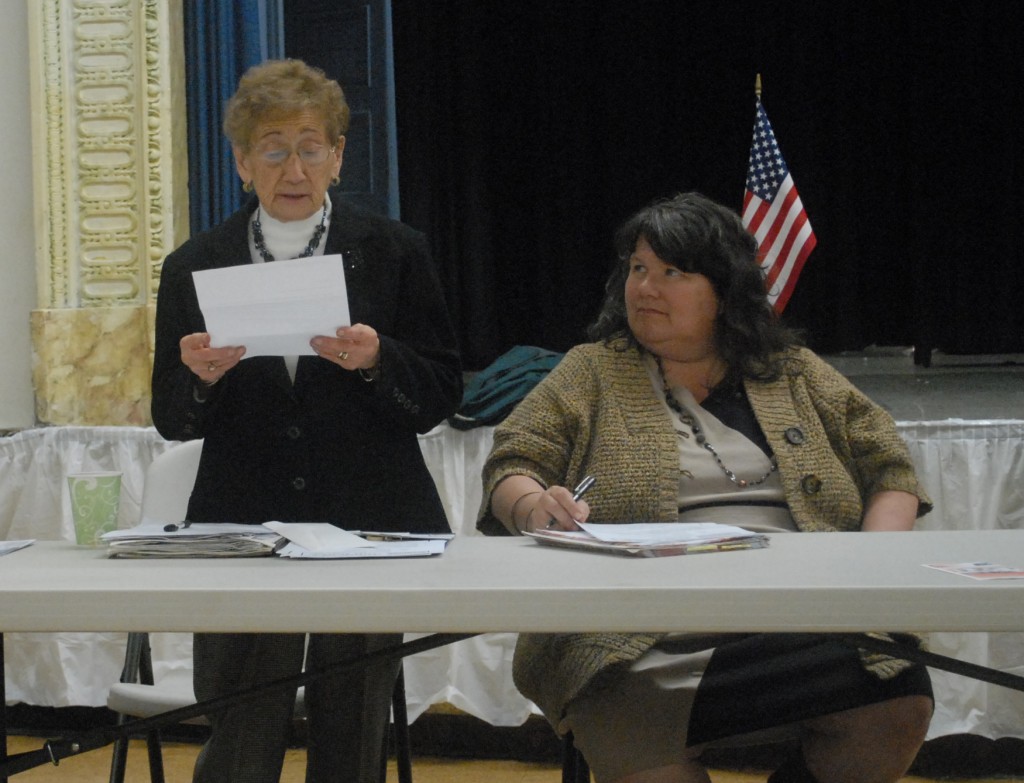 Ann Maggio, left, pictured at a meeting last year reading a letter her group, Citizens for a Better Ridgewood, received from Grover Cleveland High School thanking them for helping staff and students fight the city’s plan to close the school. After proposing to phase out the school, the city opted to keep the institution open last year. File Photo