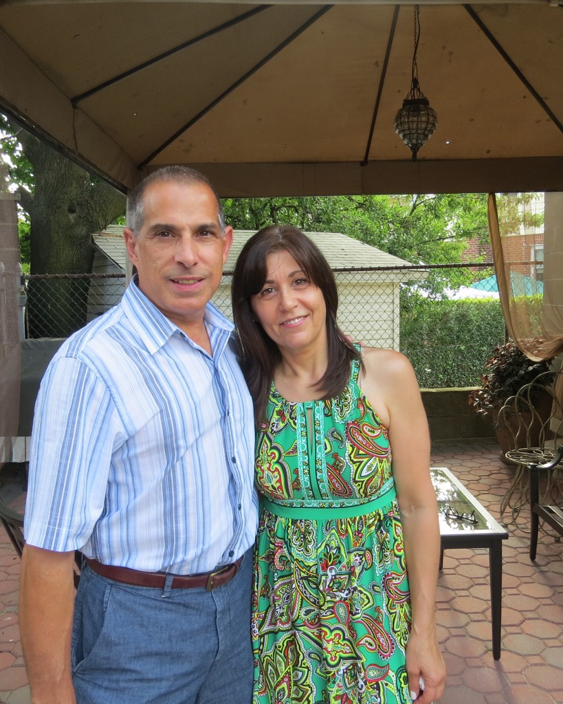 John Manzione and his wife, Darlaina, stand in their Maspeth back yard, from where the two heard their neighbors screaming for help on July 4. John Manzione rushed to the scene, with his wife not far behind him, where he performed life-saving CPR on a 22-month-old boy. Anna Gustafson/The Forum Newsgroup