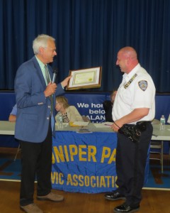 Juniper Park Civic Association President Bob Holden, left, presents Lt. James Lombardi, previously of the 104th Precinct, with an award for his service to the area at a JPCA meeting in June. Anna Gustafson/The Forum Newsgroup