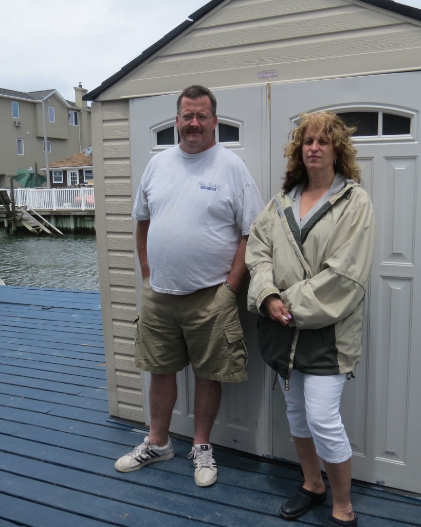 Mike McLoughlin and Sophia Vailakis-DeVirgilio stand outside her home in Broad Channel, where McLoughlin was attacked by two thieves stealing copper piping from her house that has been vacant since Hurricane Sandy. Anna Gustafson/The Forum Newsgroup