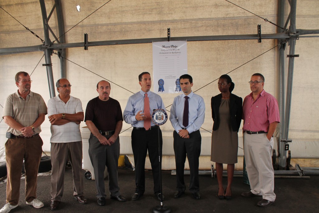 State Assemblyman Phil Goldfeder, center at podium, and Councilman Eric Ulrich, third from right, called on mayoral candidates to back a permanent ferry service from Rockaway to Manhattan. Photo Courtesy NYS Assembly