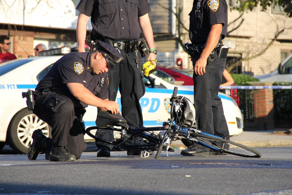 Police gather around a bicycle ridden by a man struck in Howard Beach last week. The victim died from injuries he sustained. Richard York/The Forum Newsgroup 
