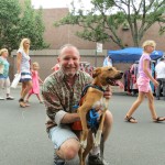 Steve Fischer, a volunteer with Heavenly Angels, and Marie, a Mountain Cur, spend time at the fair. Heavenly Angels members spoke to festival goers about pet adoption.