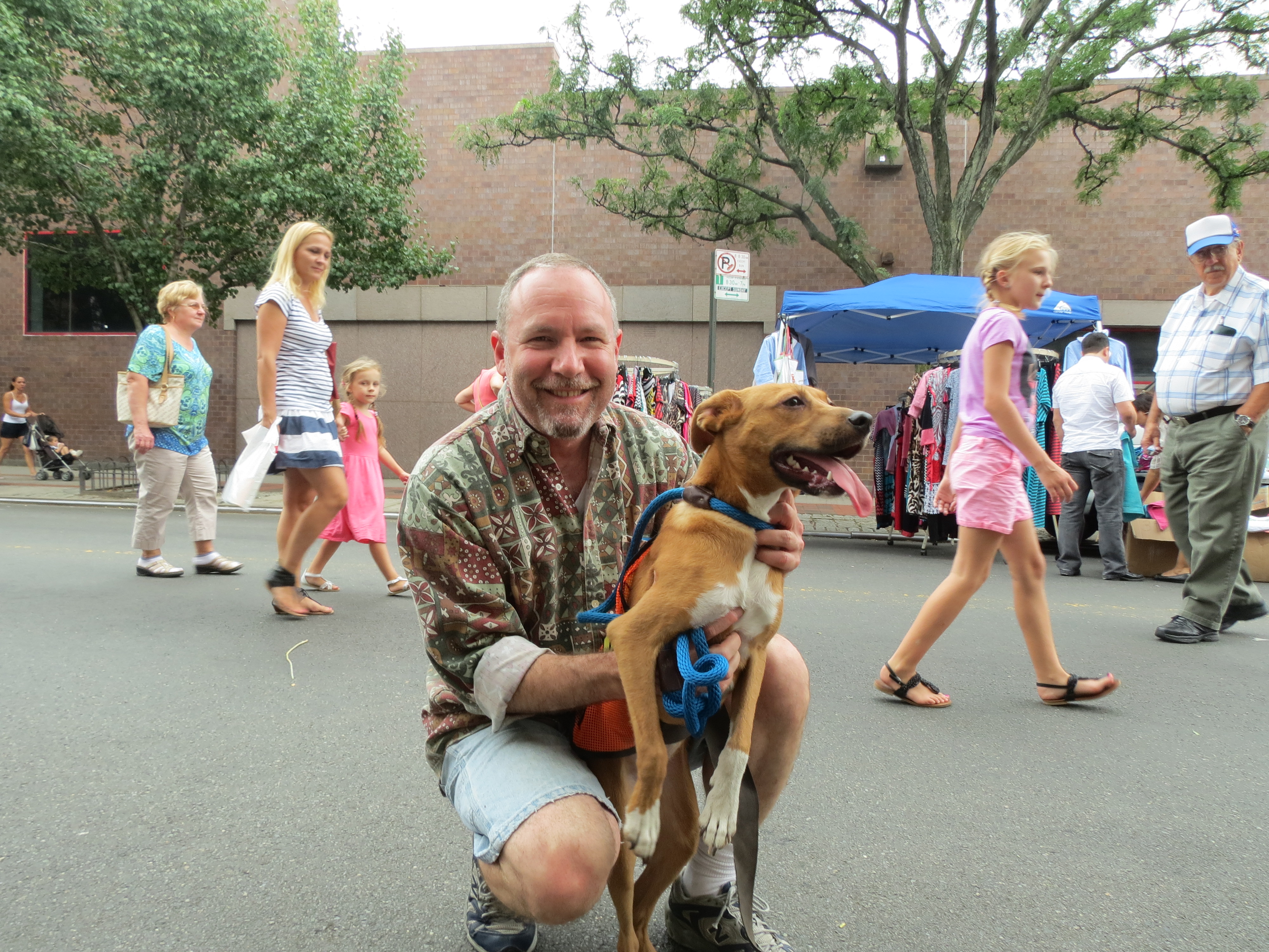 Steve Fischer, a volunteer with Heavenly Angels, and Marie, a Mountain Cur, spend time at the fair. Heavenly Angels members spoke to festival goers about pet adoption.