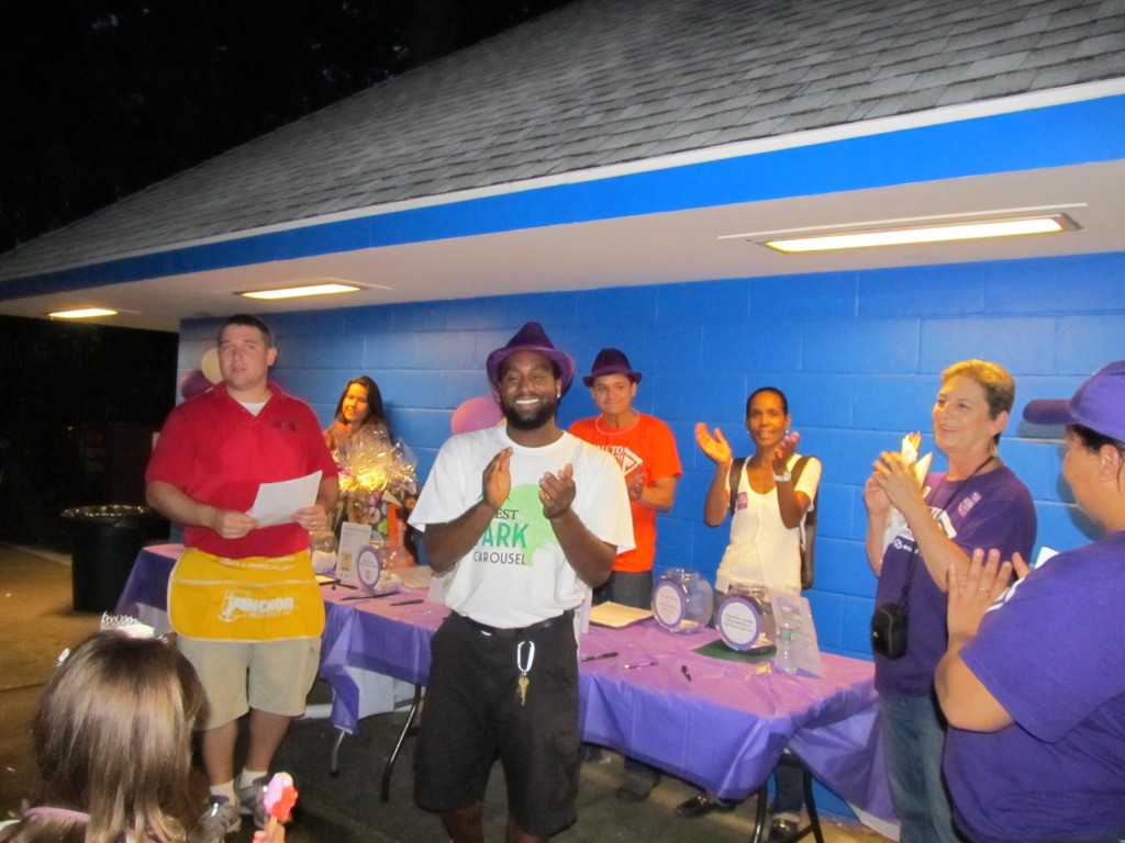 Carol Lacks, second from right, gathered with individuals from the New York City Chapter of the Alzheimer's Association and other volunteers at a fundraiser at the Forest Park Carousel last Friday evening. Photo Courtesy Josephine Wendell