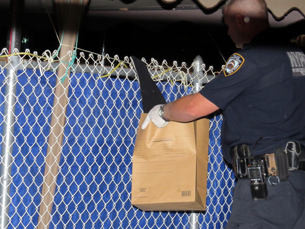 The navy blue hoodie worn by the suspect is bagged for evidence after being found on a fence the suspect jumped over.