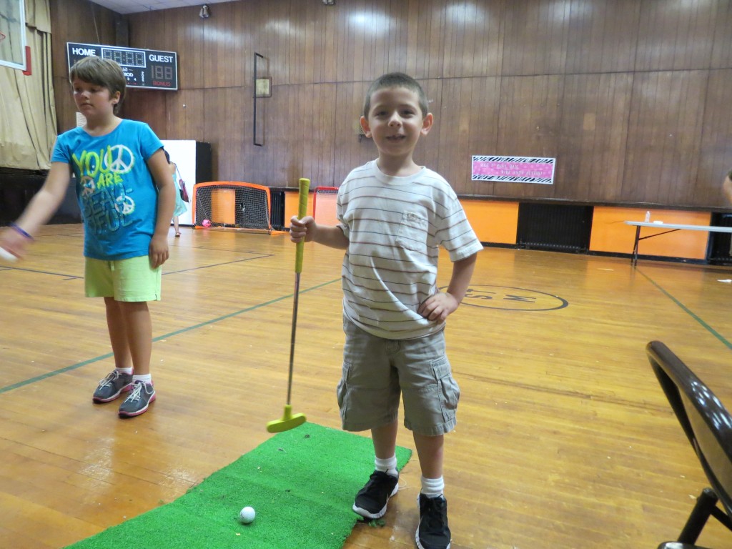 Sebastian Caracci, 6, showed off his miniature golf skills at the fundraiser.
