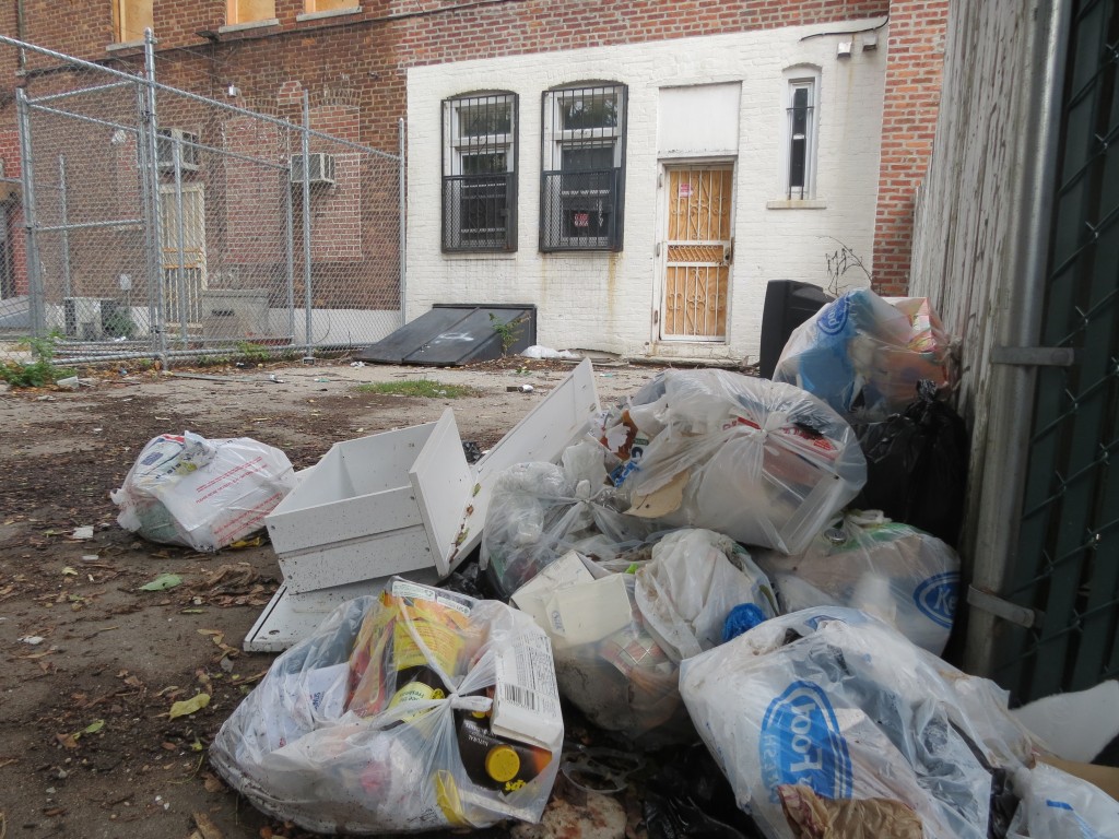 Ozone Park residents said individuals dump trash into the yard of an abandoned house on Rockaway Boulevard between 105th and 107th streets. Anna Gustafson/The Forum Newsgroup 