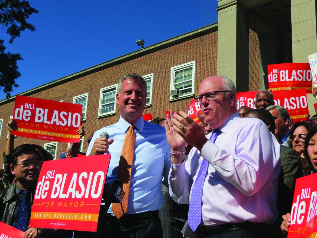 Public Advocate Bill de Blasio, center, landed an endorsement for the Democratic candidate's bid for mayor from U.S. Rep. Joseph Crowley and the Queens County Democrats outside Queens Borough Hall Monday.  Anna Gustafson/The Forum Newsgroup