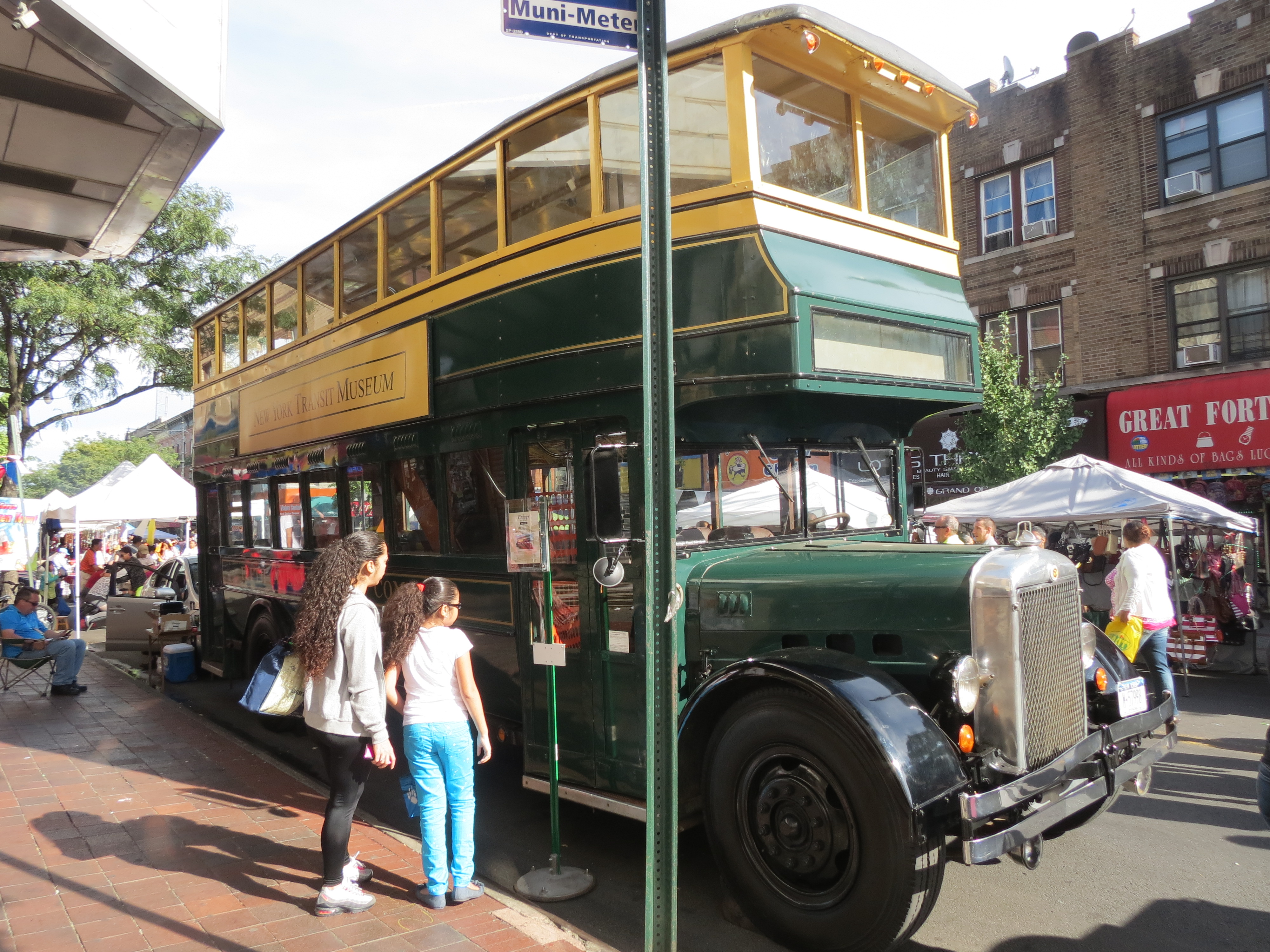 A double decker Fifth Avenue Coach Company bus, one of a number of vintage vehicles displayed at the festival, was parked outside the Ridgewood Theater. The bus operated from 1931 to 1953 and ran along the Fifth Avenue routes in Manhattan.