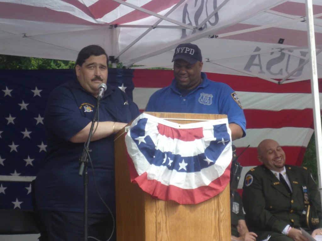 Assemblyman Mike Miller, left, presents 102nd Precinct Community Affairs Officer Jose Severino with a plaque of appreciation.