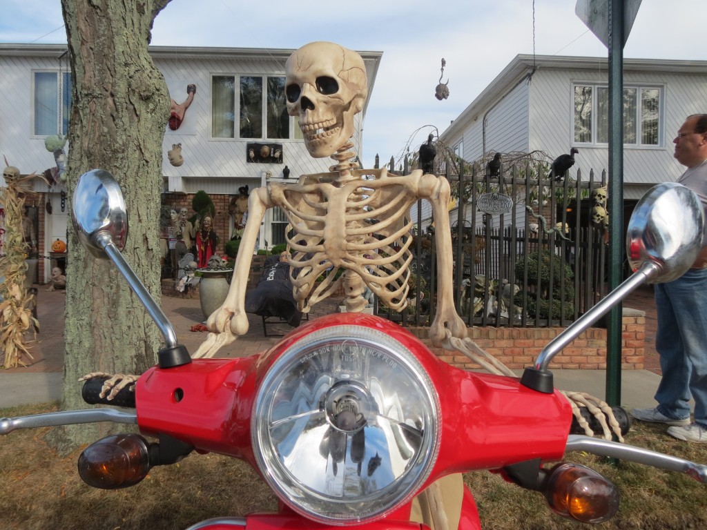 A skeleton rides atop a gleaming red motorcycle outside Nick Colavito's Howard Beach home. Anna Gustafson/The Forum Newsgroup