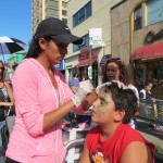 Yaheli Mordechai, 8, of Briarwood, sits patiently as his face is painted.
