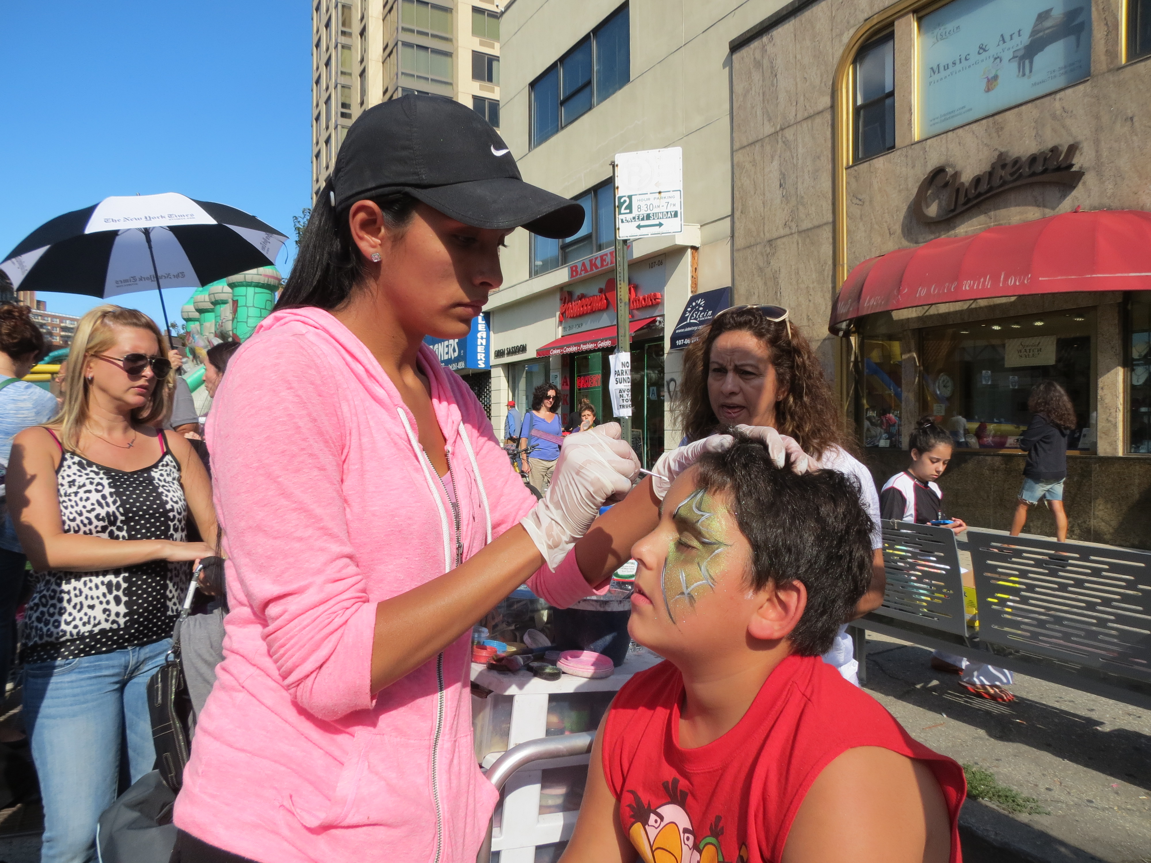 Yaheli Mordechai, 8, of Briarwood, sits patiently as his face is painted.