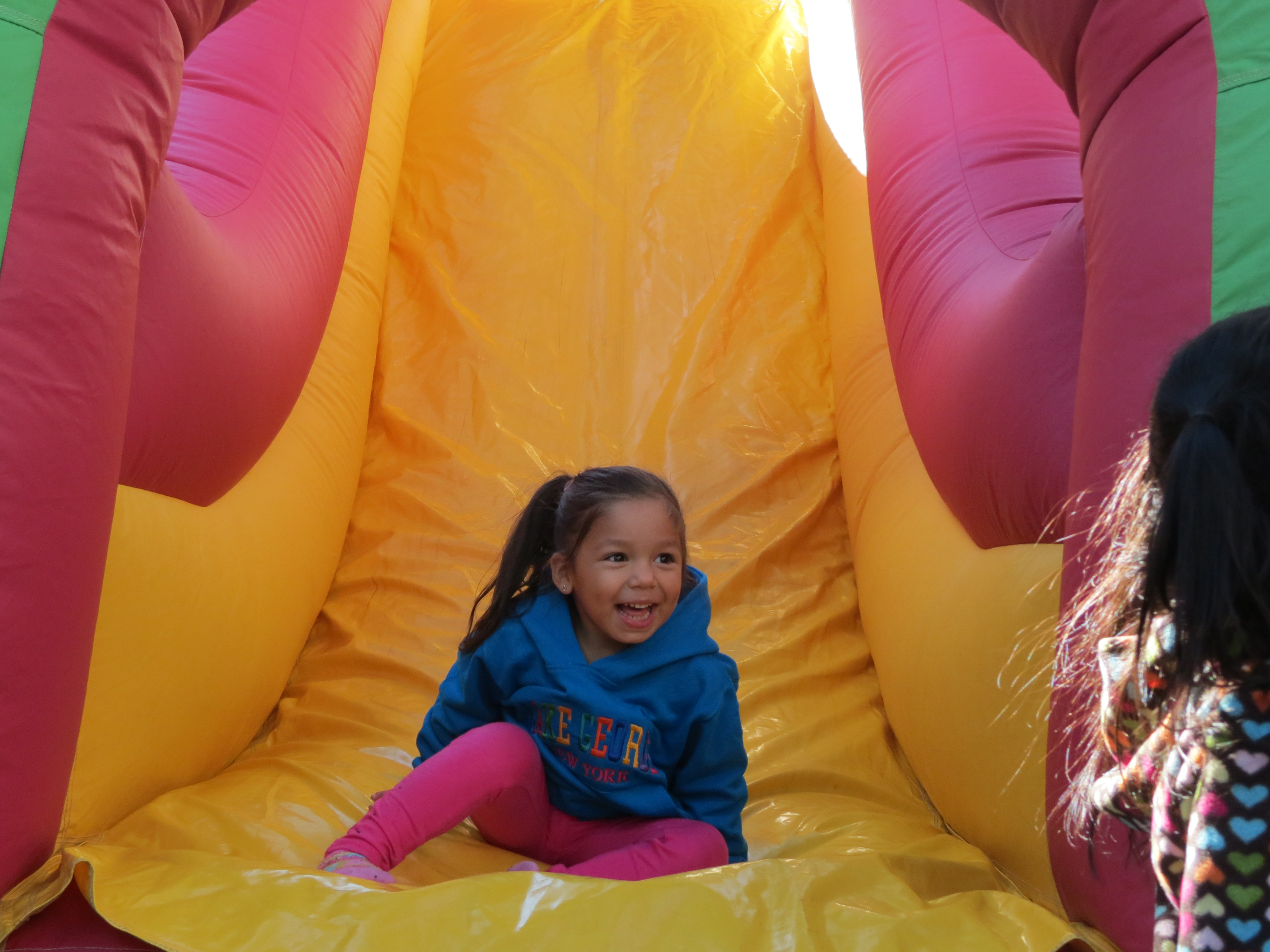 Children lined up by the dozen to fly down a number of inflatable slides at the festival.