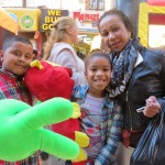 Elliott, 8, left; Jada, 9; and Jackie Ortiz, all of Woodhaven, show off the goodies they won at the fair.