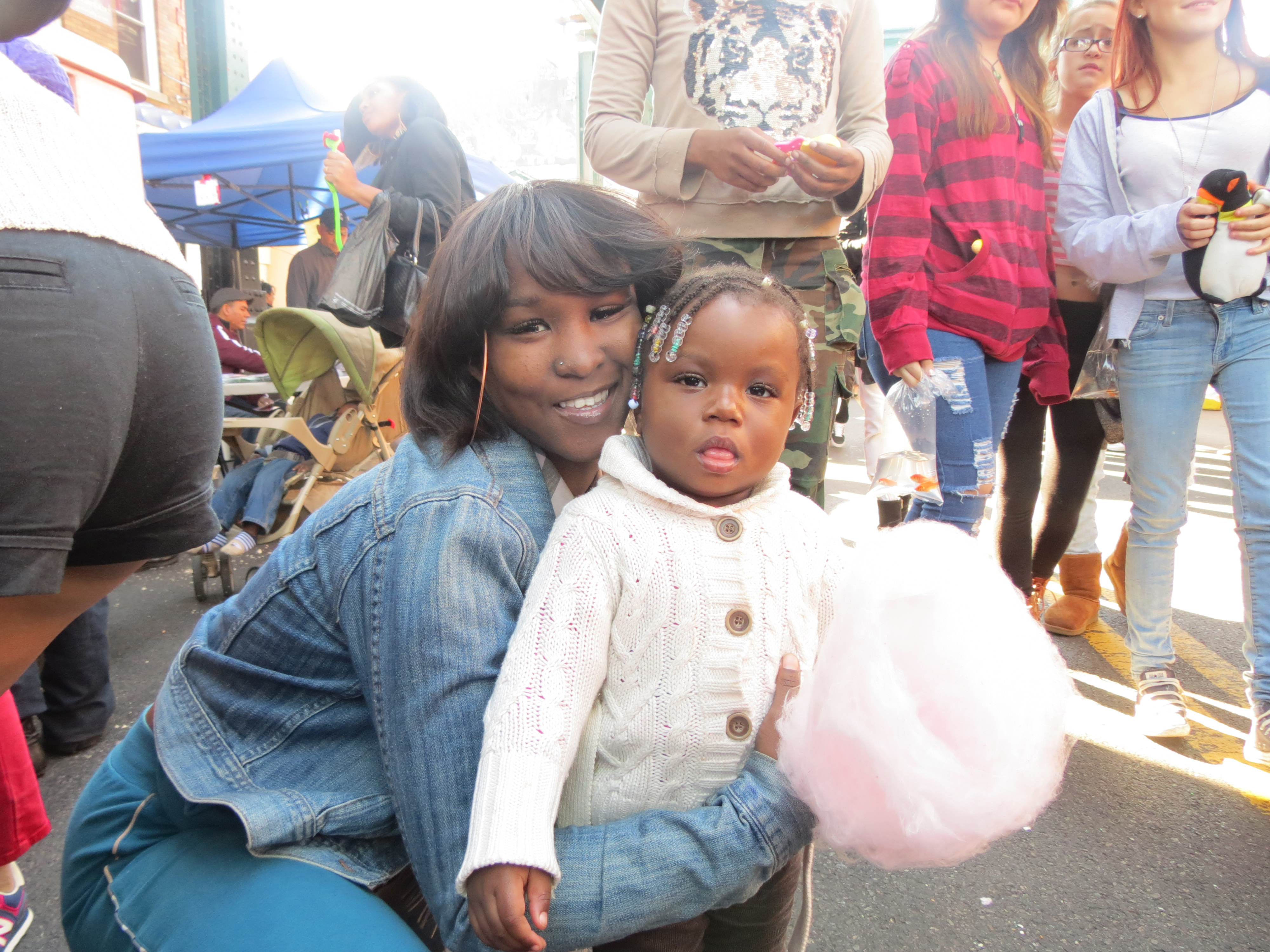 Pebbles, left, and Tiyanna Spencer, 1, enjoy the cotton candy that was plentiful at the festivities.