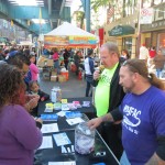 Mike Brothers, left, and Frank Scafo, of the New York Families for Autistic Children, talk to residents about their organization. NYFAC works with children with autism and their families from throughout Queens - and beyond. NYFAC board of directors members also held a raffle at their booth to help raise money for the nonprofit, and the winner landed a $500 prize.