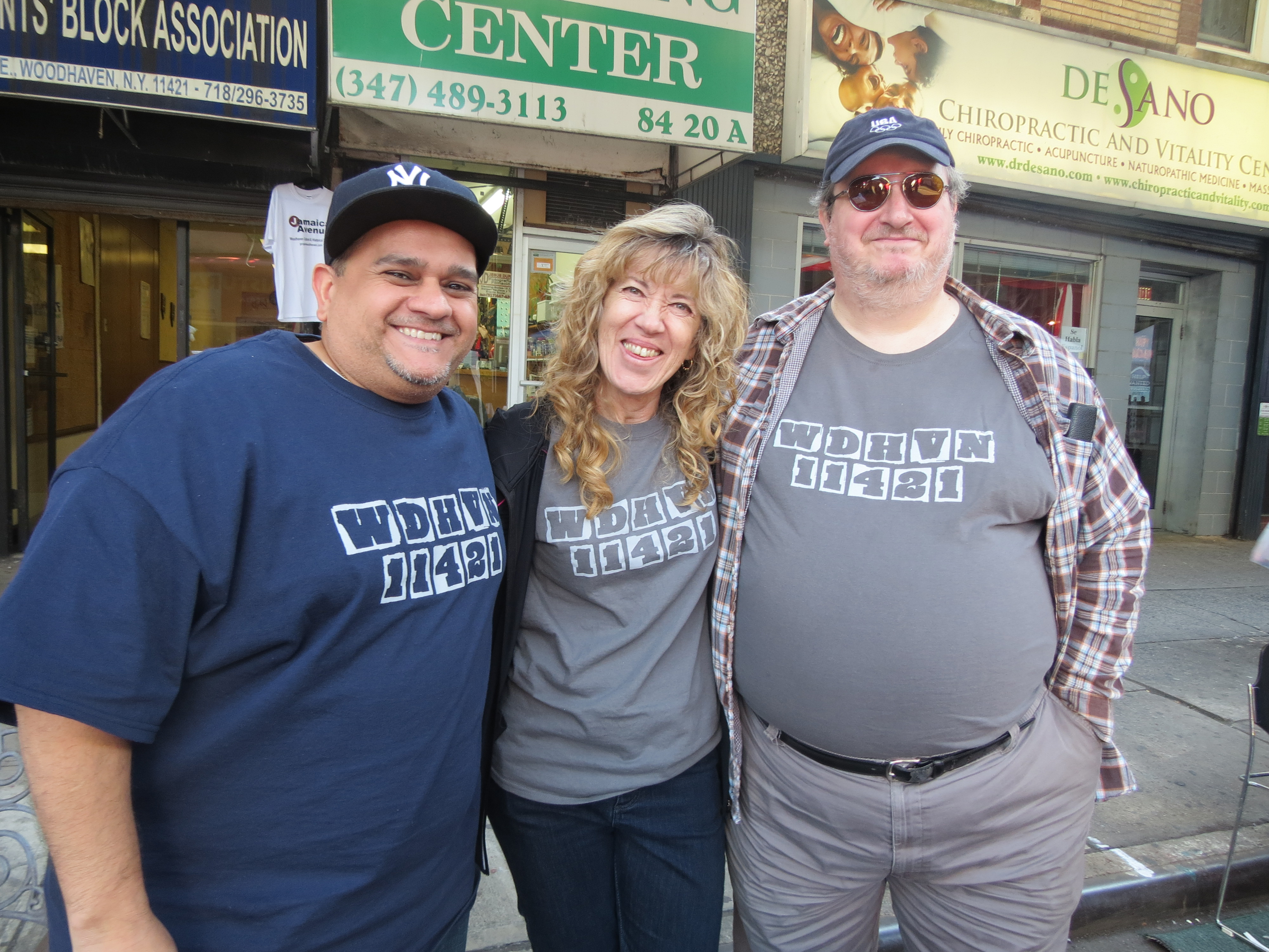 Woodhaven Residents’ Block Association members Martin Colberg, left, Giedra Kregzdys, and Steve Forte sold shirts emblazoned with the neighborhood’s zip code on the front to support their civic group.