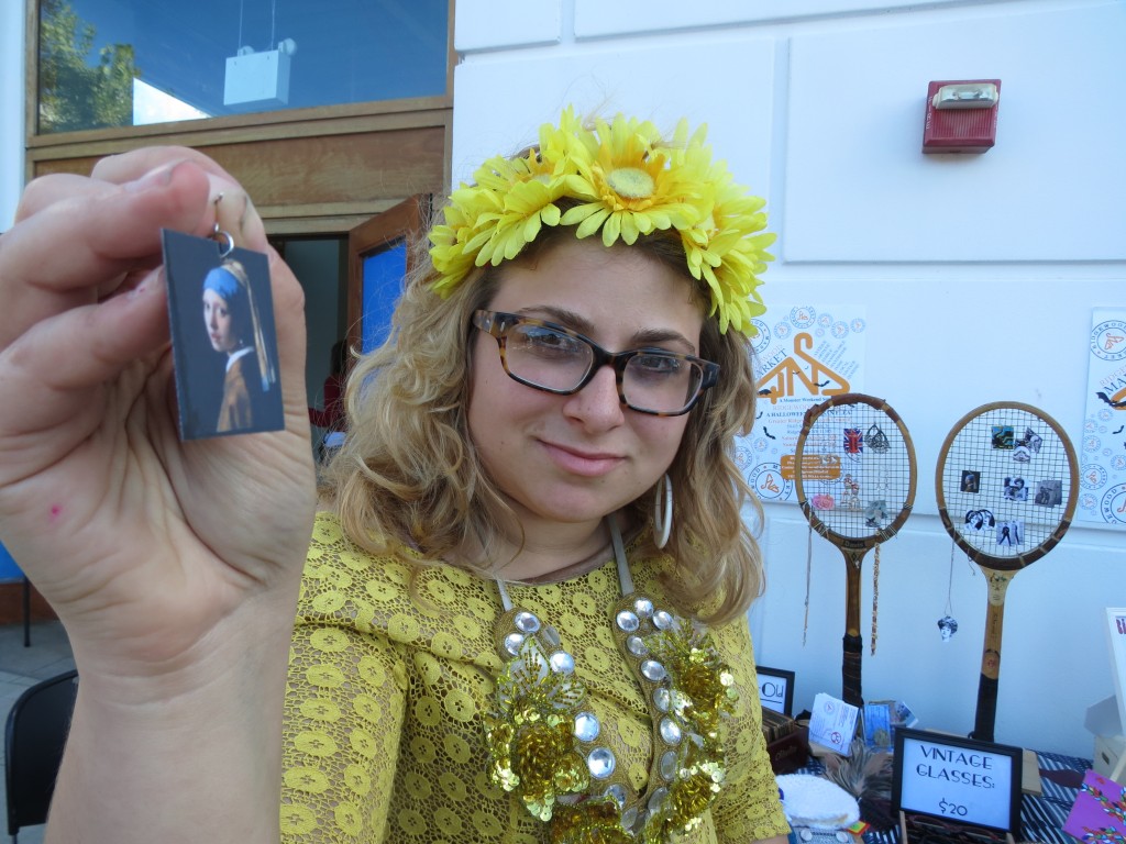 Ridgewood Market founder Sarah Feldman shows off one of the earrings she made. Feldman sold earrings, as well as a variety of other eclectic goods, at the Atlas Park event.