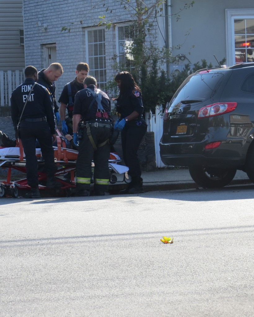 Paramedics and FDNY attend to an 18-year-old woman who was struck after stepping of the curb at the Bridgeton Street corner residents say is so dangerous it's a surprise to them someone hasn't been killed at the location. Patricia Adams/The Forum Newsgroup