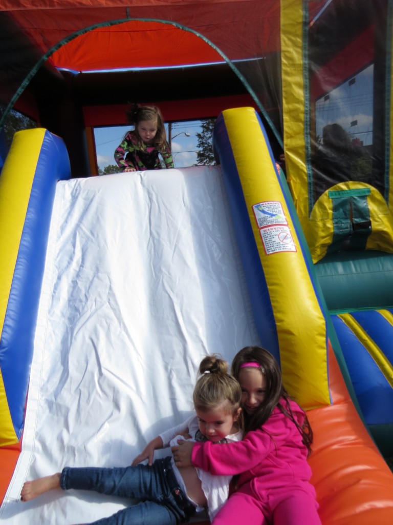 Two-year old Gianna was happy for the helping hand from Ashley Horning, 6, after realizing just how “too big” the slide out of the bouncy castle was.