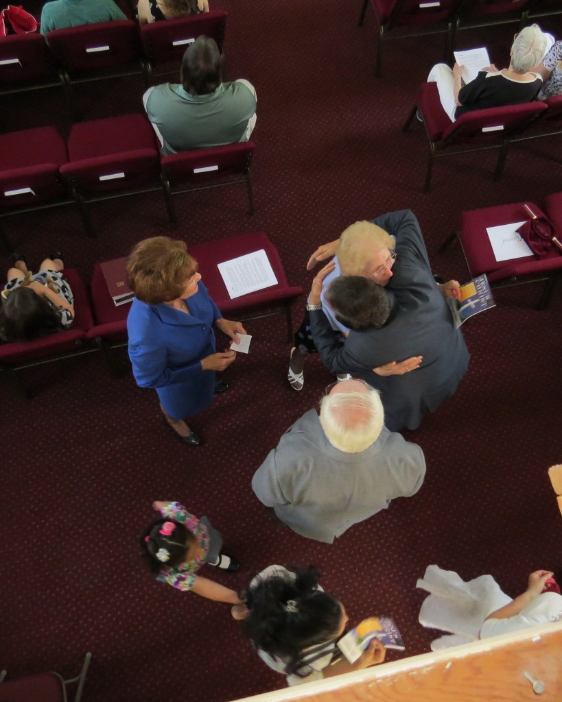 Howard Beach Assembly of God Pastor Stephen Roser hugs one of his congregants at the church's rededication ceremony in June. File Photo
