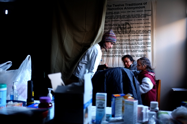 A Doctors Without Borders physician examines patients in a makeshift medical clinic in a building at the Ocean Village housing complex in Arverne, Rockaway days after Sandy hit. Photos Courtesy Doctors Without Borders/Michael Goldfarb