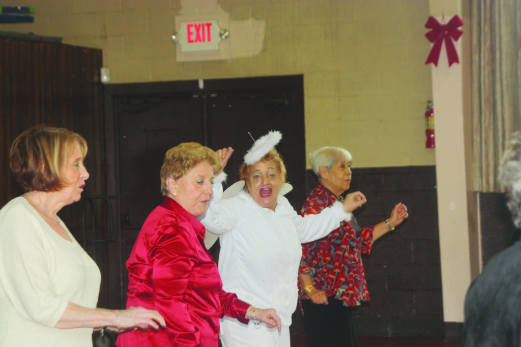 St. Helen's provided space for the Howard Beach Senior Center to operate until it moved to its new home this summer. Here, seniors dance at St. Helen's at the space where individuals were also able to receive counseling and other support to deal with the aftermath of Hurricane Sandy. File Photo 