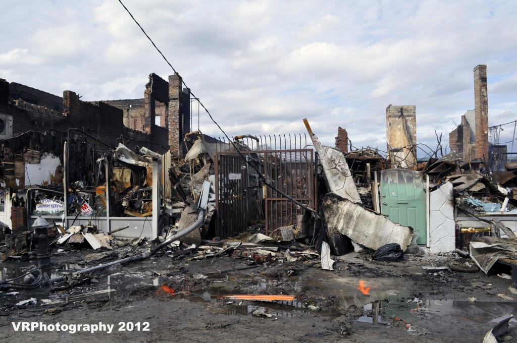 Reports of devastation across the Rockaway peninsula came in at a frightening pace. This row of stores along Rockaway Beach Boulevard was one of several commercial strips to burn to the ground after fires from downed power lines burned out of control. Some of the fires burned for as long as four days. Photo Courtesy Victoria Holt/VRPhotography
