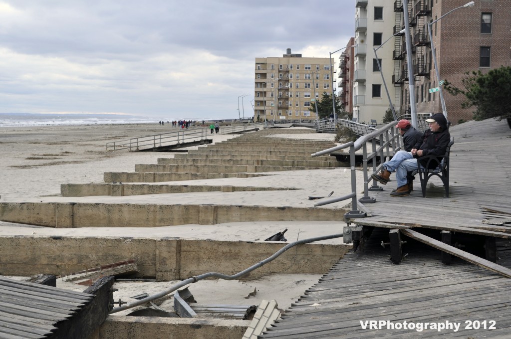 Residents sit and marvel at the destruction along the shoreline that claimed sections of the boardwalk for dozens of blocks tossing them as though they were toothpicks.
