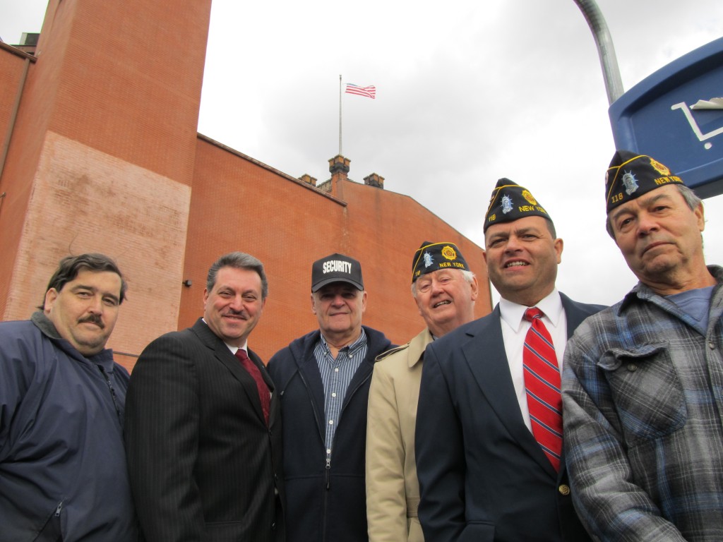 State Assemblyman Mike Miller, left, state Sen. Joe Addabbo Jr., and area veterans congregated Friday at the clock tower in Ozone Park to fly an American flag for the first time in nearly 10 years. Photos Courtesy Ed Wendell 