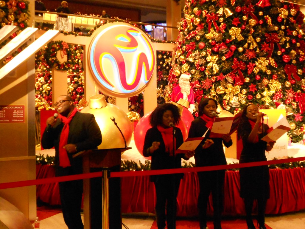 Carolers entertained the crowd at the Resorts World Christmas tree lighting with many festive holiday tunes.