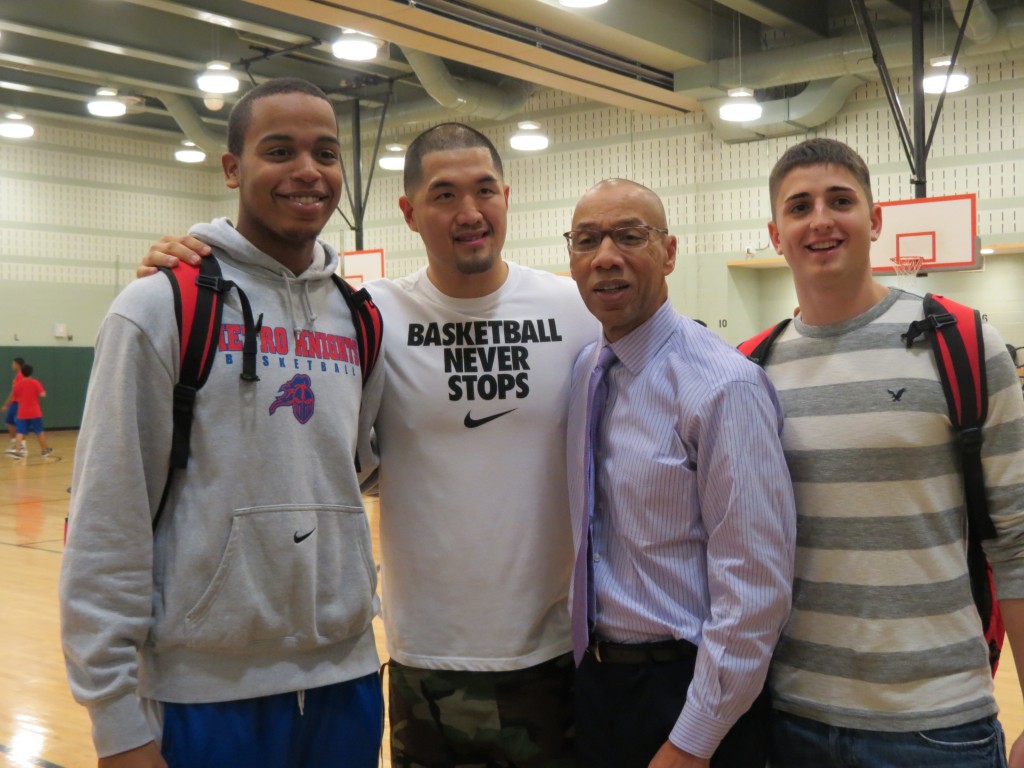 Schools Chancellor Dennis Walcott, second from right, joked that Queens Metropolitan HS basketball player Abel Matos, left, head coach Jeffrey Loh, and player Corey Hill made him feel particularly short.