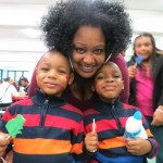 Kimberly Gulley and her 4-year-old twin sons, Markus and Markem, have fun at the festivities at PS 232.