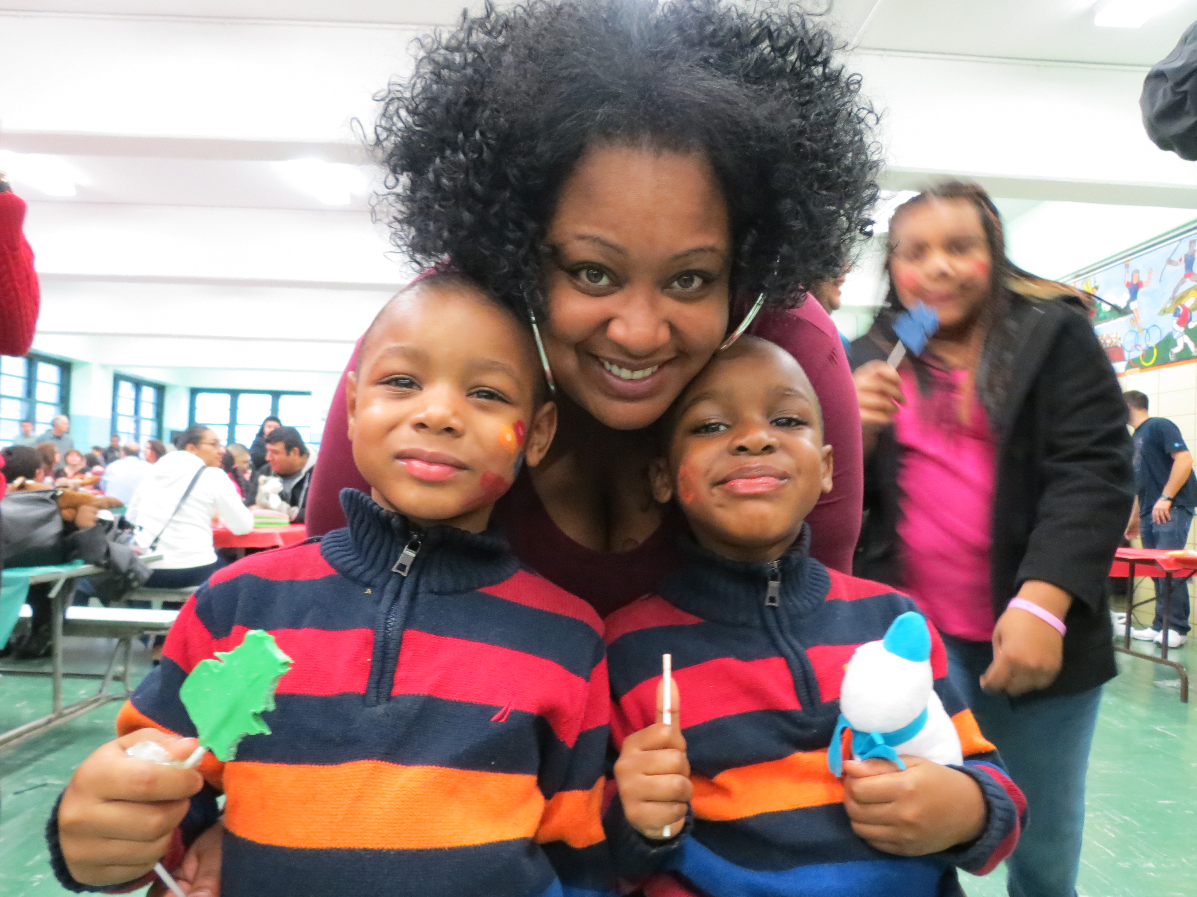 Kimberly Gulley and her 4-year-old twin sons, Markus and Markem, have fun at the festivities at PS 232.