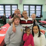Michael McKeon, front left, 14, and Nicholi Constantine, 16, spend time with their families at the holiday party.