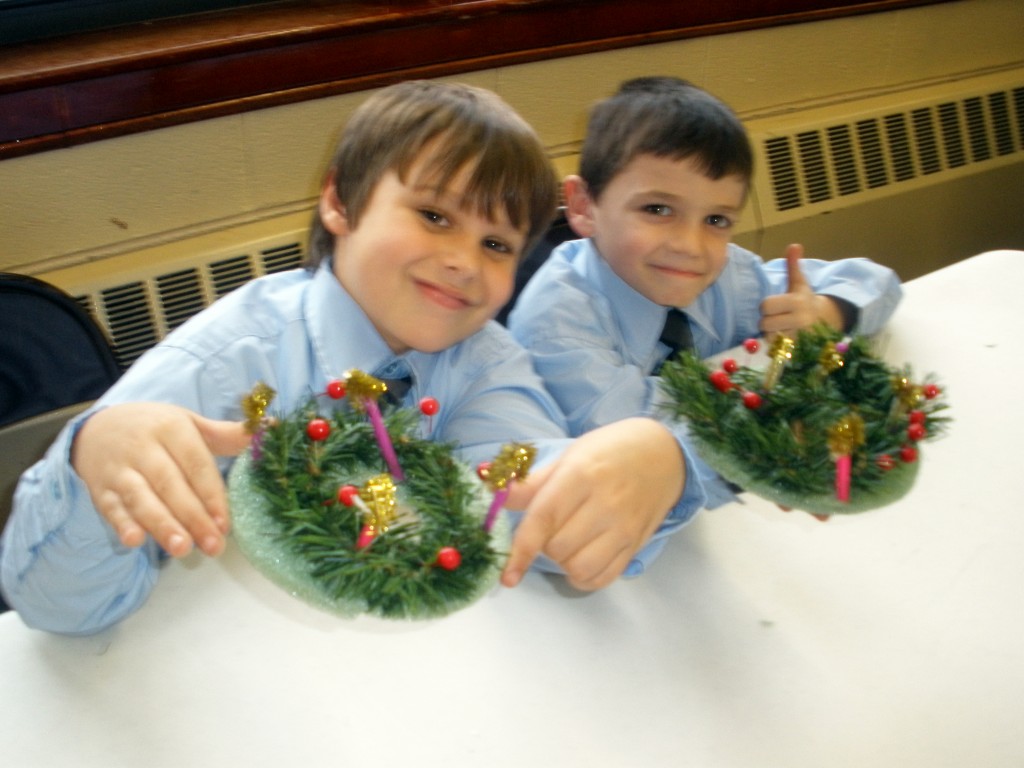 St. Helen's School engaged students in various activities to prepare for the celebration of Christmas. Here two proud young men display their obvious prowess in making beautiful advent wreaths. Photos Courtesy St. Helen School 