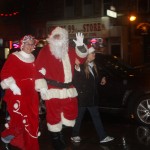 Santa and Mrs. Claus braved the rain and got a warm welcome from a cold and wet crowd.