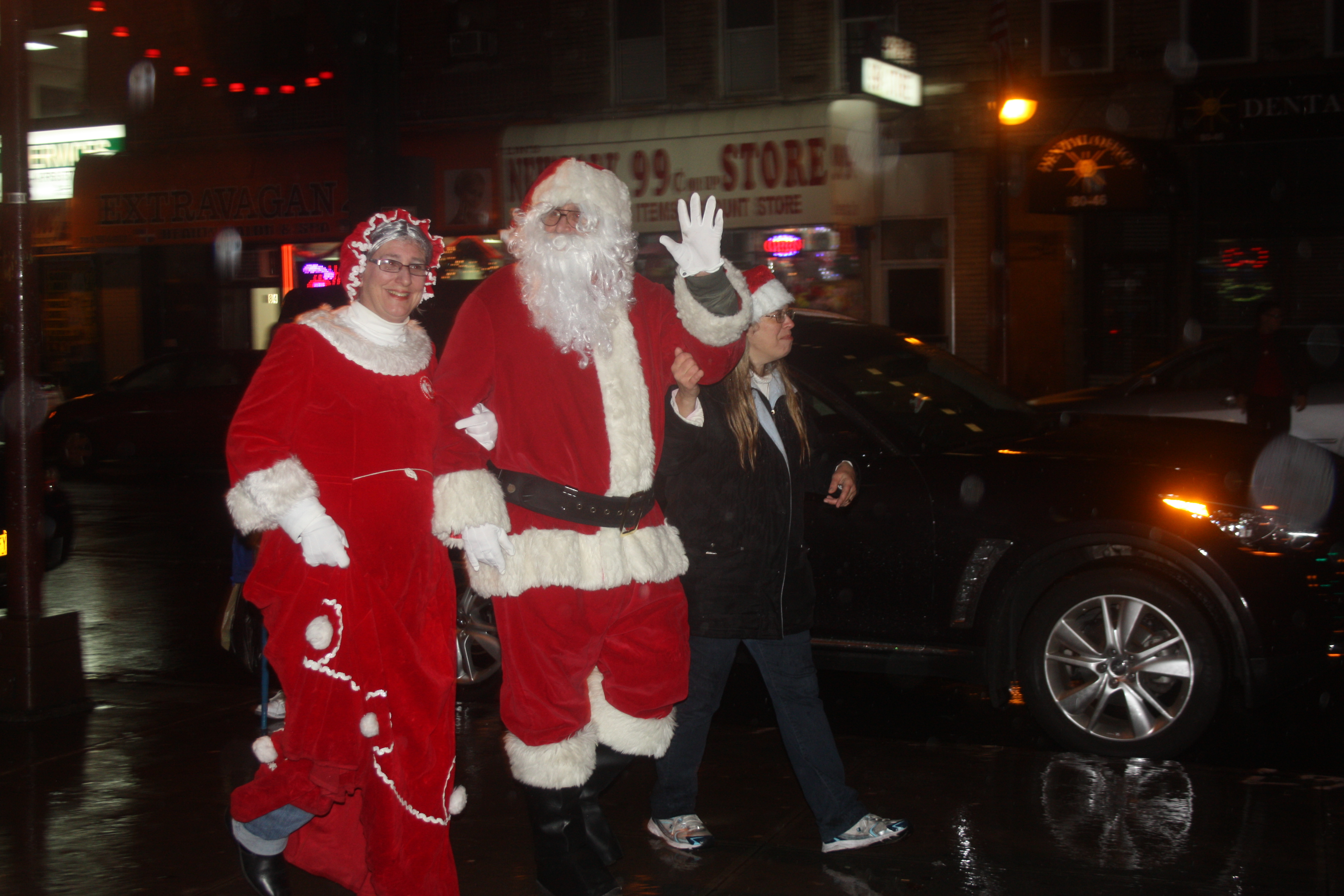Santa and Mrs. Claus braved the rain and got a warm welcome from a cold and wet crowd.