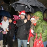 Rain wasn’t enough to dampen the spirits of families who crowded under umbrellas waiting for the countdown to light the tree.