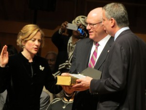 Mayor de Blasio, right, administers the oath of office to Melinda Katz during Katz's inauguration as Queens' 19th borough president. Holding the Old Testament used for the swearing-in was U.S. Rep. Joseph Crowley, chairman of the Queens County Democratic Organization. The copy of the Old Testament they used had been given to Katz's late father, David Katz, founder of the Queens Symphony Orchestra, by former Queens County District Attorney Frank O'Connor.  Photos by Anna Gustafson