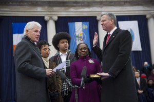 Mayor Bill de Blasio takes the oath of office from former U.S. President Bill Clinton as his wife Chirlane McCray and children Dante and Chiara watch during his inaugural ceremony at City Hall.  Photo courtesy NYC Mayor's Office.