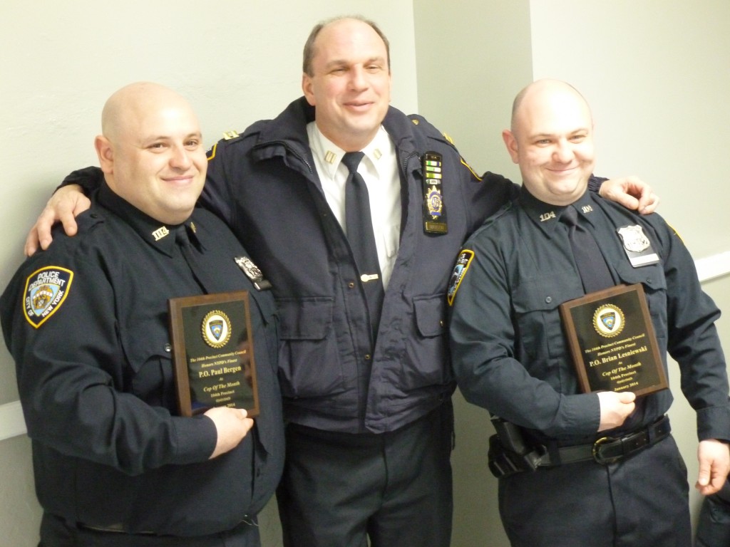 04th Capt. Christopher Manson, center, honors Officers Paul Bergen, left, and Brian Lesniewski for their exemplary police work at the precinct's community council meeting on Tuesday evening.  Photo by Phil Corso