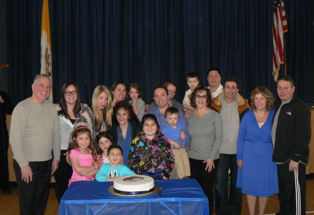Deacon Alex Breviario and his family members who were in attended help him cut the cake Sunday, when the deacon was honored for his extraordinary service to the church community.